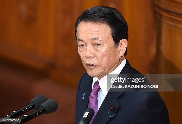 Japan's Finance Minister Taro Aso delivers a speech on the first day of the 150-day ordinary Diet session at the National Diet in Tokyo on January...