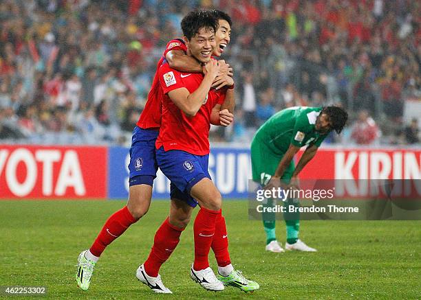 Kim Young Gwon of Korea Republic celebrates with team mate Ki Sung Yueng after scoring a goal during the Asian Cup Semi Final match between Korea...