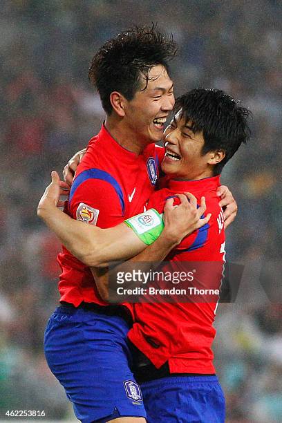 Kim Young Gwon of Korea Republic celebrates with team mate Ki Sung Yueng after scoring a goal during the Asian Cup Semi Final match between Korea...