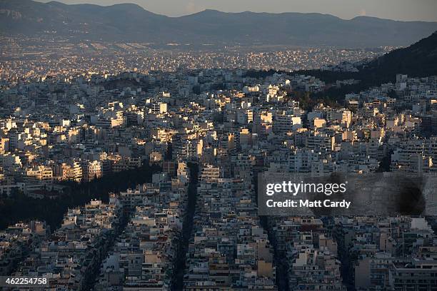 The sun begins to rise over Athens seen from the summit of Mount Lycabettus following the electoral success by Syriza in the Greek general election...