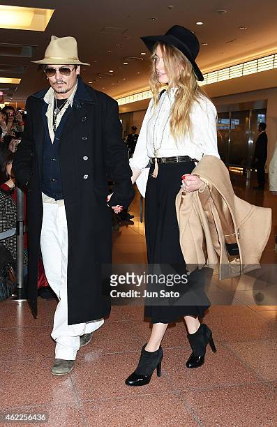Johnny Depp and Amber Heard are seen upon arrival at Haneda Airport on January 26, 2015 in Tokyo, Japan.