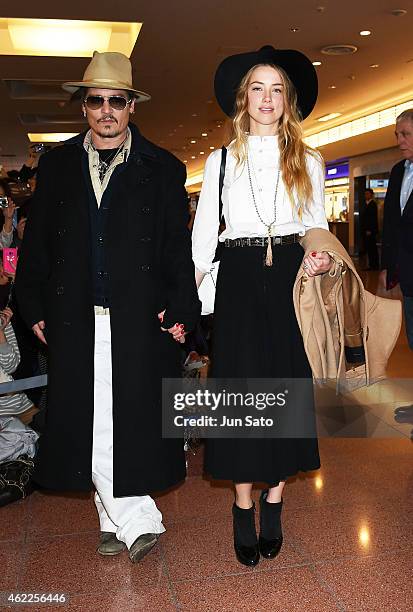 Johnny Depp and Amber Heard are seen upon arrival at Haneda Airport on January 26, 2015 in Tokyo, Japan.