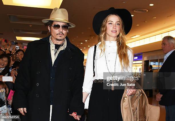 Johnny Depp and Amber Heard are seen upon arrival at Haneda Airport on January 26, 2015 in Tokyo, Japan.