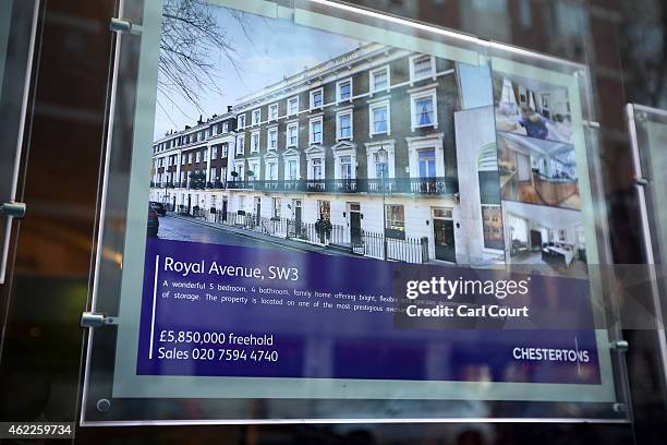 An advert for a luxury property is seen in the window of an estate agent on January 23, 2015 in west London, England. The Labour Party has proposed a...