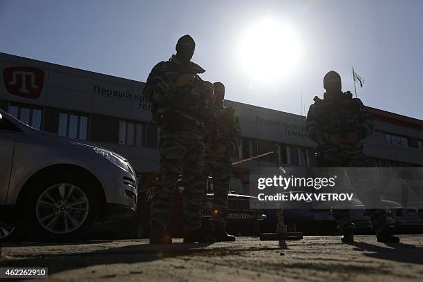 Officers of the Russian riot police force OMON stand guard outside the offices of Crimean Tatar TV channel ATR in Simferopol on January 26, 2015. A...