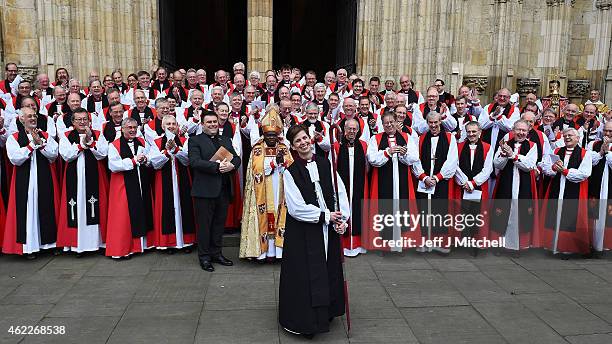 The Reverend Libby Lane smiles as she stands near the Archbishop of Canterbury, Justin Welby, and the Archbishop of York, Dr John Sentamu outside...