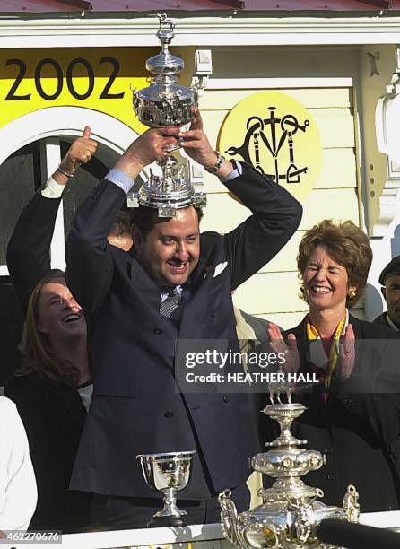 Saudi Prince Ahmed bin Salman puts a replica of the Woodlawn vase on his head after his horse War Emblem won the 127th running of the Preakness...