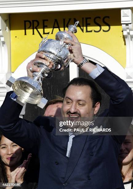 War Emblem's owner Saudi Prince Ahmed bin Salman holds up the Woodlawn Vase after the 127th Preakness Stakes 18 May 2002 at Pimlico race track in...