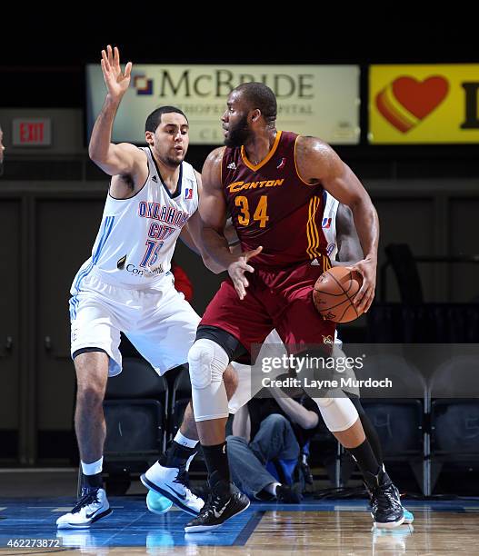 Arinze Onuaku of the Canton Charge posts up Grant Jerrett of the Oklahoma City Blue during an NBA D-League game on January 23, 2015 at the Cox...