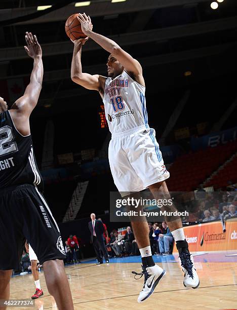 Grant Jerrett of the Oklahoma City Blue shoots against Keith Wright of the Austin Spurs during an NBA D-League game on January 24, 2015 at the Cox...