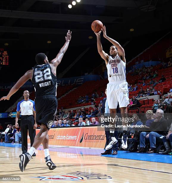 Grant Jerrett of the Oklahoma City Blue shoots the ball against Keith Wright of the Austin Spurs during an NBA D-League game on January 24, 2015 at...