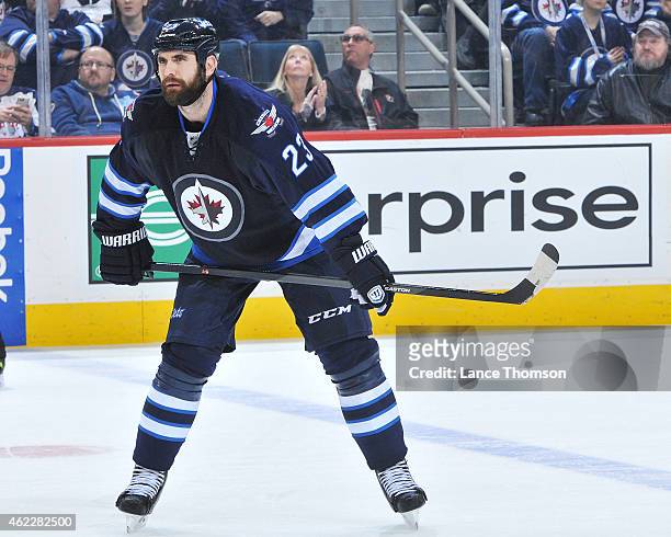 Jay Harrison of the Winnipeg Jets gets set for a third period face-off against the Arizona Coyotes on January 18, 2015 at the MTS Centre in Winnipeg,...
