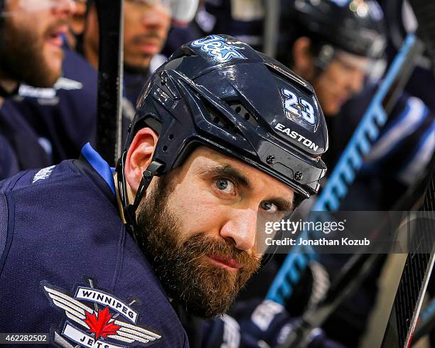 Jay Harrison of the Winnipeg Jets looks on from the bench during second period action against the Arizona Coyotes on January 18, 2015 at the MTS...