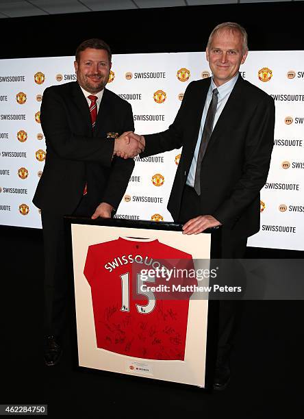 Of Swissquote Mark Burki of Manchester United is presented with a gift by Managing Director Richard Arnold of Manchester United after a press...