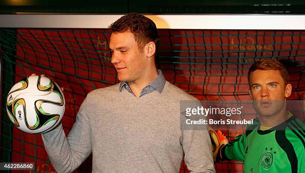 Goalkeeper Manuel Neuer of Germany poses with his wax figure at Madame Tussauds on January 26, 2015 in Berlin, Germany.