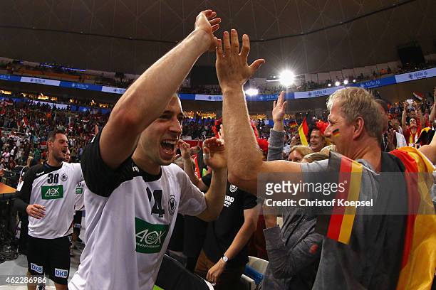 Patrick Groetzki of Germany celebrates with the fans after the eight final match between Germany and Egypt at Lusail Multipurpose Hall on January 26,...