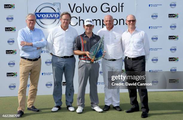 Louis Oosthuizen of South Africa holding the trophy with Per Ericsson The President of Volvo Event Management on his immediate right after the final...