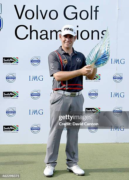 Louis Oosthuizen of South Africa holds the trophy after his victory during the final round of the 2014 Volvo Golf Champions at Durban Country Club on...