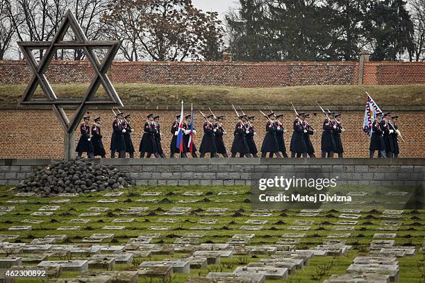 Czech honour guard members walk past David's star a day before the International Holocaust Remembrance Day at the cemetery at the Terezin Memorial on...