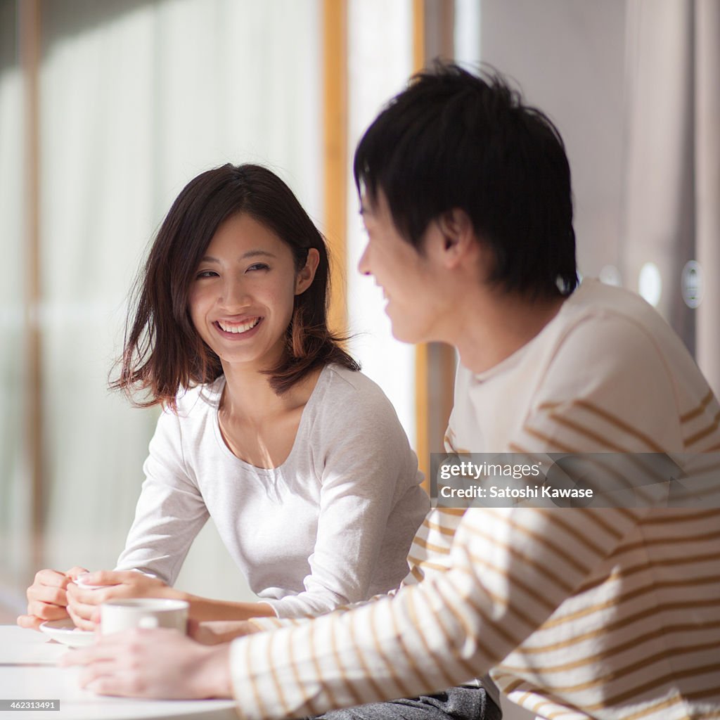 Young couple chatting at an open cafe