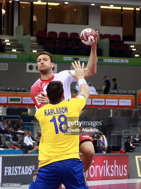 Tobias Karlsson of Sweden in action against Slawomir Szmal of Poland during the Qatar 2015 24th Men's Handball World Championship Round of 16 match...