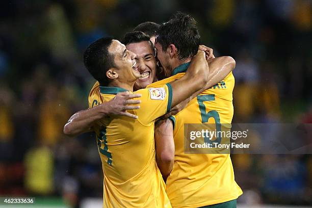 Tim Cahill Jason Davidson and Mark Milligan of Australia celebrate a goal during the Asian Cup Semi Final match between the Australian Socceroos and...