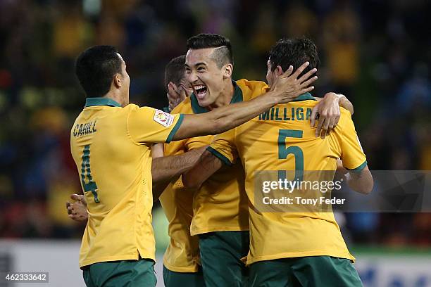 Tim Cahill Jason Davidson and Mark Milligan of Australia celebrate a goal during the Asian Cup Semi Final match between the Australian Socceroos and...