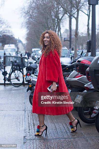 Jewelry designer Natashe Zinko wears a Dior coat, Brian Atwood shoes on day 2 of Paris Haute Couture Fashion Week Spring/Summer 2015, on January 26,...