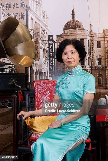 April 19: Wang Weiyu poses in a Qipao traditional dress in front of things that evoke Shanghai in the thirties: ancient furniture, an old record...