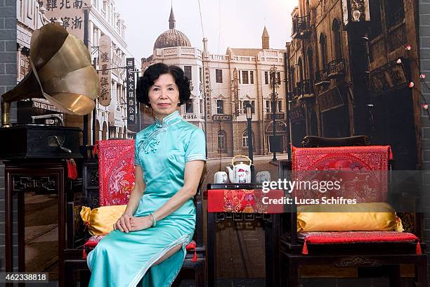 April 19: Wang Weiyu poses in a Qipao traditional dress in front of things that evoke Shanghai in the thirties: ancient furniture, an old record...