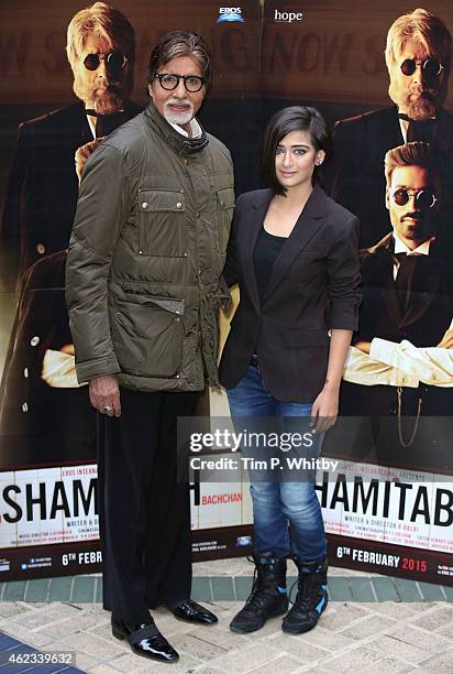 Actors Amitabh Bachchan and Akshara Haasan attend a photocall for "Shamitabh" at St James Court Hotel on January 27, 2015 in London, England.