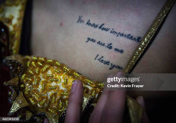 Chinese drag queen who goes by the stage name Baomei displays a tattoo backstage at the Chunai 98 club on January 9, 2015 in Nanning, Guangxi...