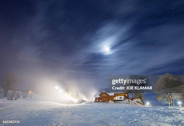 Long time exposed picture shows snowmakers blowing artificial snow on a slope on the eve of the men's night slalom of the FIS Alpine Skiing World Cup...