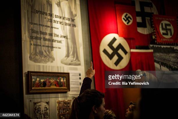 Person points to a display as they visit the Yad Vashem museum to see the exhibition and commemorate International Holocaust day on January 27, 2015...