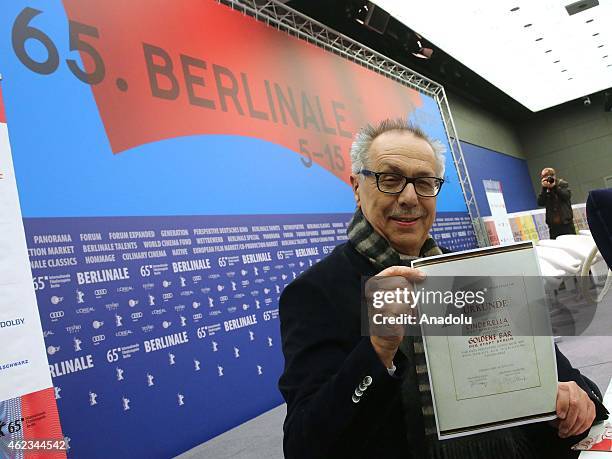 Dieter Kosslick, Director of Berlinale Festival, poses with an old certificate from 1951 for the Golden Bear for the film 'Cinderella' during the...