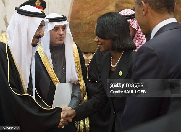 Saudi new King Salman shakes hands with former US Secretary of State Condoleezza Rice , alongside US President Barack Obama, at the Erga Palace in...