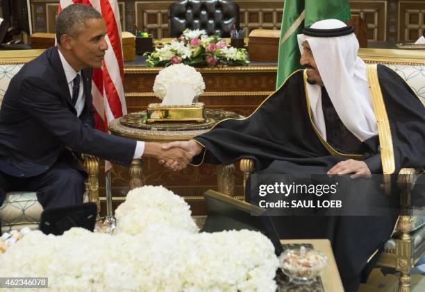 Saudi's newly appointed King Salman shakes hands with US President Barack Obama at Erga Palace in Riyadh on January 27, 2015. Obama landed in Saudi...