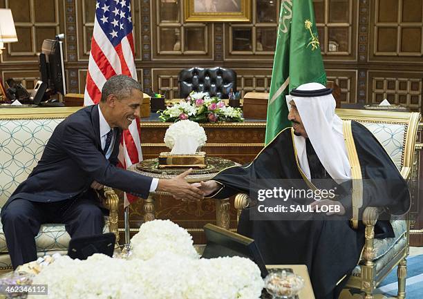 Saudi's newly appointed King Salman shakes hands with US President Barack Obama at Erga Palace in Riyadh on January 27, 2015. Obama landed in Saudi...