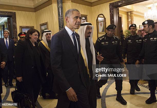 President Barack Obama walks alongside Saudi's newly appointed King Salman at Erga Palace in Riyadh on January 27, 2015 following his arrival in...