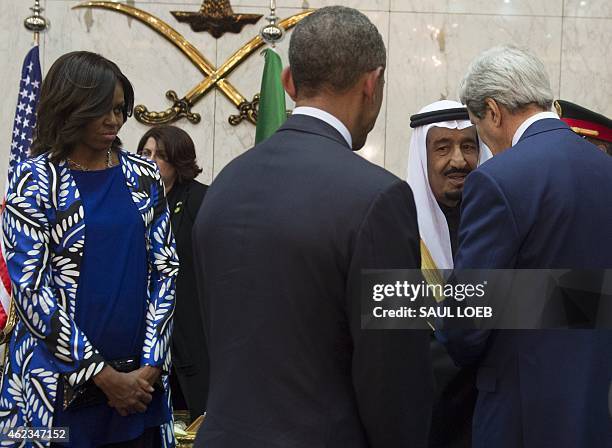 Secretary of State John Kerry speaks with Saudi's newly appointed King Salman as US President Barack Obama and First Lady Michelle Obama listen on at...