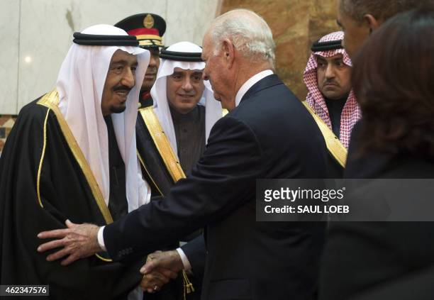 Saudi's newly appointed King Salman shakes hands with former US secretary of state James Baker at Erga Palace in Riyadh on January 27, 2015. Obama...