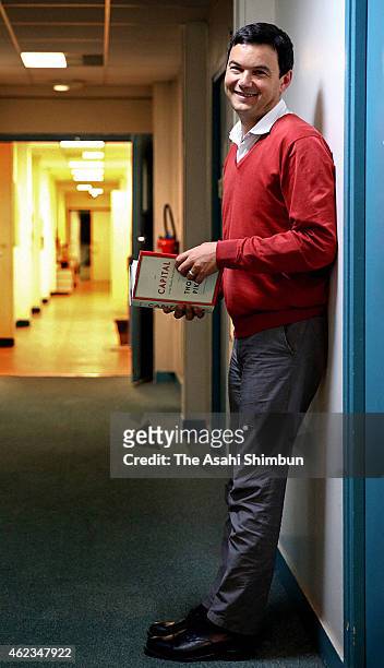 French economist Thomas Piketty poses for photographs during the Asahi Shimbun interview on December 18, 2014 in Paris, France.