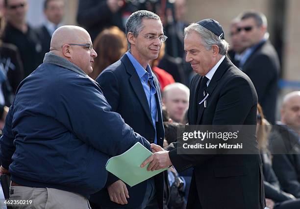 Former British Prime Minister Tony Blair shakes hands with Gilad Sharon and Omri the sons of Ariel Sharon during a state memorial service for...