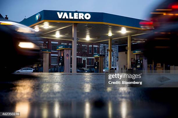 Vehicles pass a Valero Energy Corp. Gas station in Washington, D.C., U.S., on Monday, Jan. 26, 2015. Valero Energy Corp. Is expected to report...