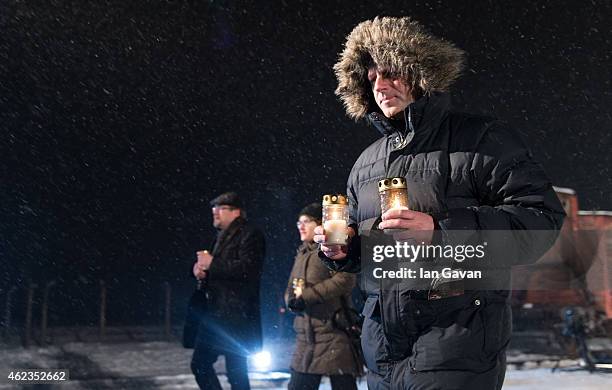 Auschwitz survivors and families visit the Birkenau Memorial carrying candles on January 27, 2015 in Oswiecim, Poland. International heads of state,...