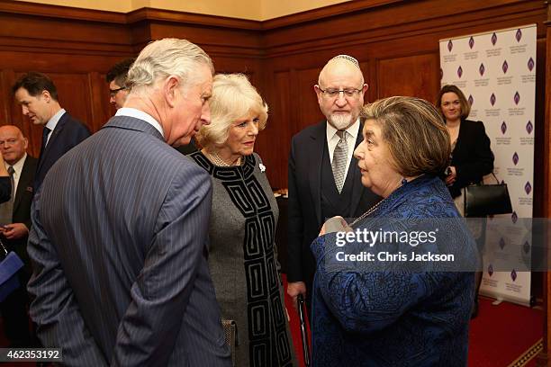 Prince Charles, Prince of Wales and Camilla, Duchess of Cornwall talk to Holocaust survivor Agnes Grunwald-Spier as they attend a Holocaust Memorial...