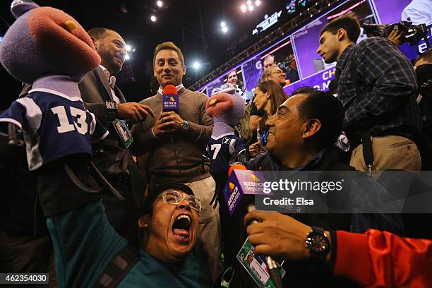 Media members from TV Azteca hold up puppets at Super Bowl XLIX Media Day Fueled by Gatorade inside U.S. Airways Center on January 27, 2015 in...