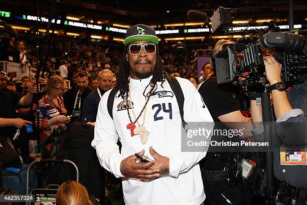 Marshawn Lynch of the Seattle Seahawks walks into Super Bowl XLIX Media Day Fueled by Gatorade inside U.S. Airways Center on January 27, 2015 in...