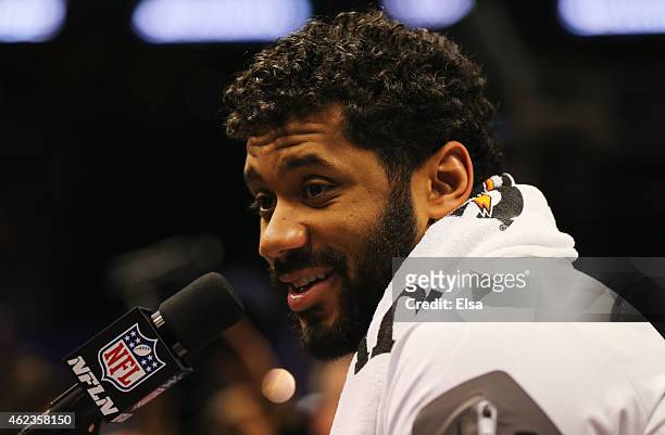 Russell Wilson of the Seattle Seahawks addresses the media at Super Bowl XLIX Media Day Fueled by Gatorade inside U.S. Airways Center on January 27,...