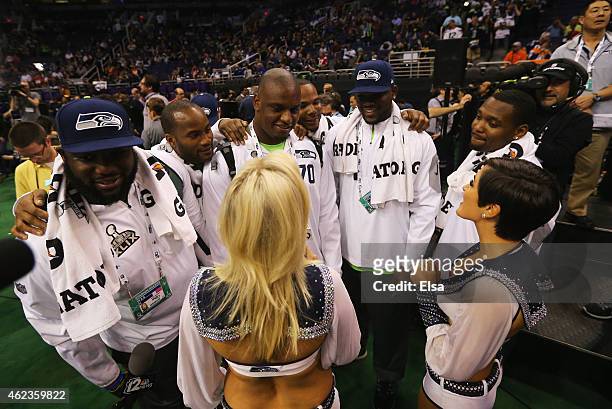 Seattle Seahawks players talk with cheerleaders at Super Bowl XLIX Media Day Fueled by Gatorade inside U.S. Airways Center on January 27, 2015 in...